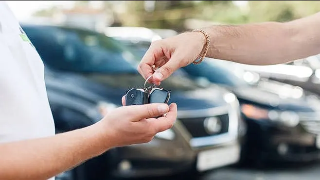 Car rental customer reviewing rental agreement and deposit terms in Oman